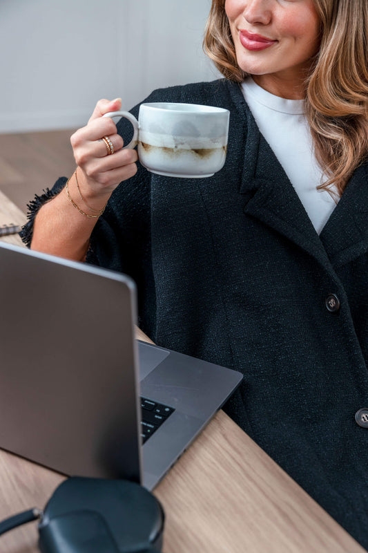 Black Smart Warmür office chair blanket styled in a boardroom setting, blending comfort and professionalism for cold office environments.