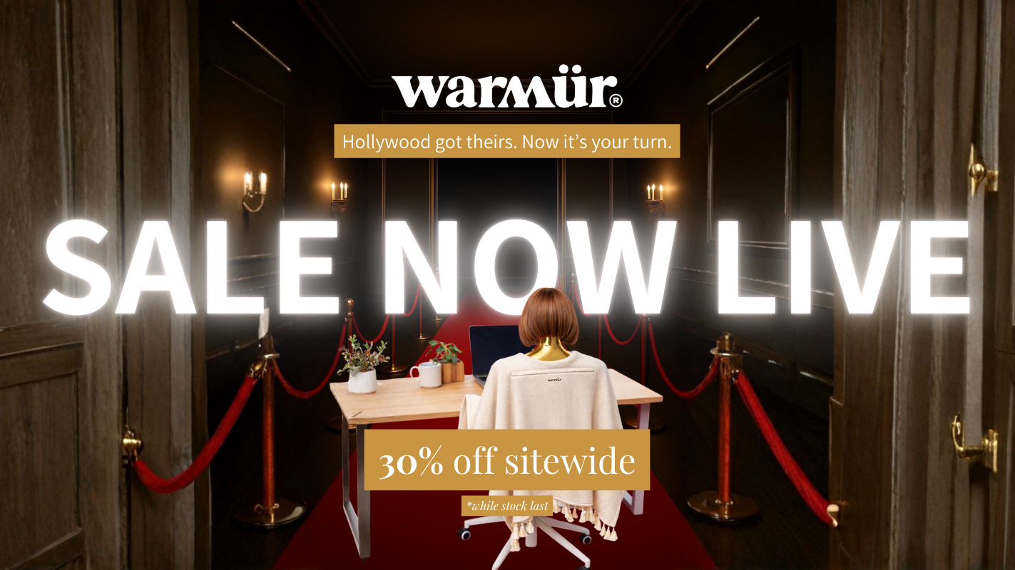 Promotional banner for a sale event with a person sitting at a desk in a room with red carpet and chandeliers, featuring the brand 'warmur'.