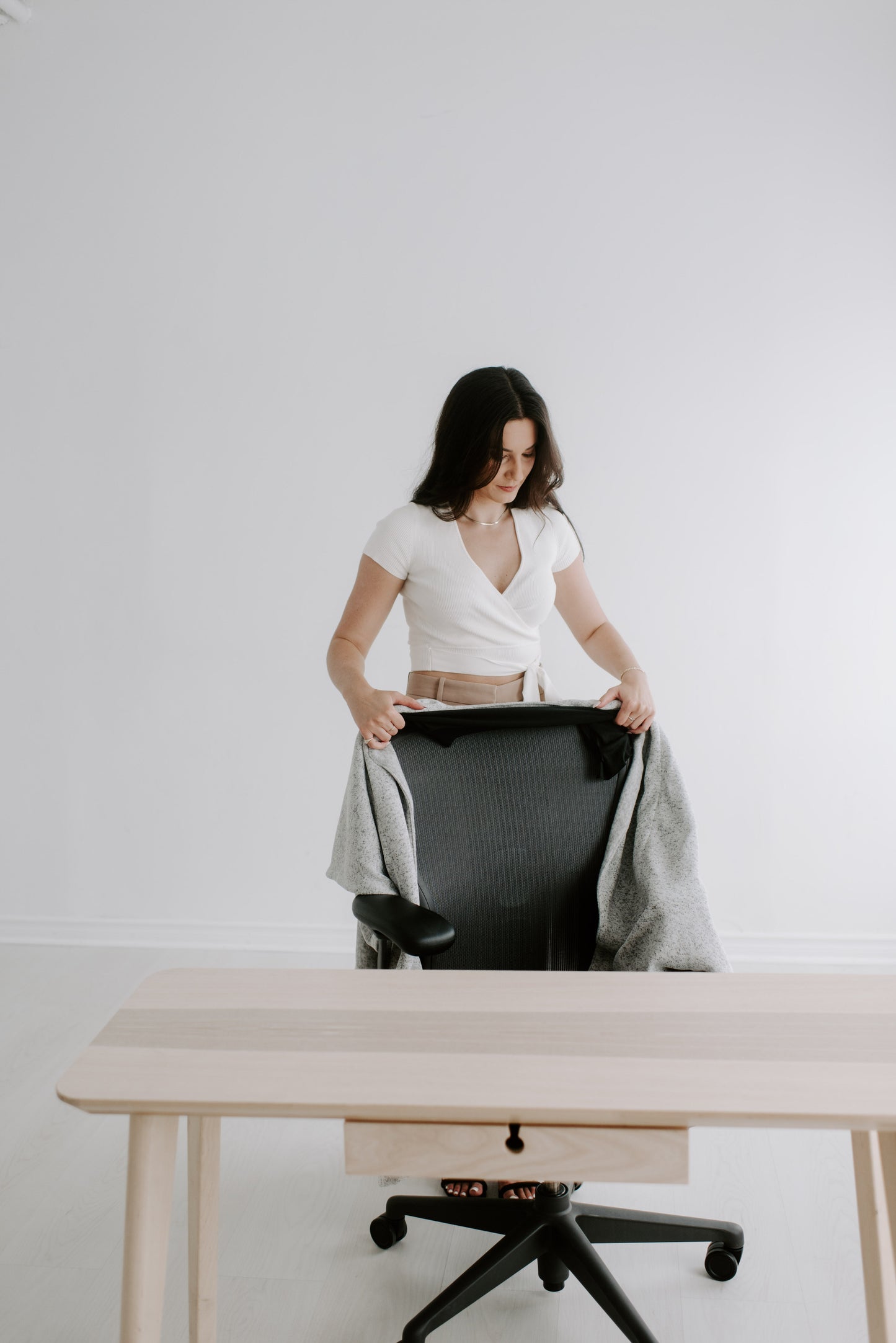 Step-one: sliding the Warmür office chair blanket’s stretch sleeve over the back of a desk chair