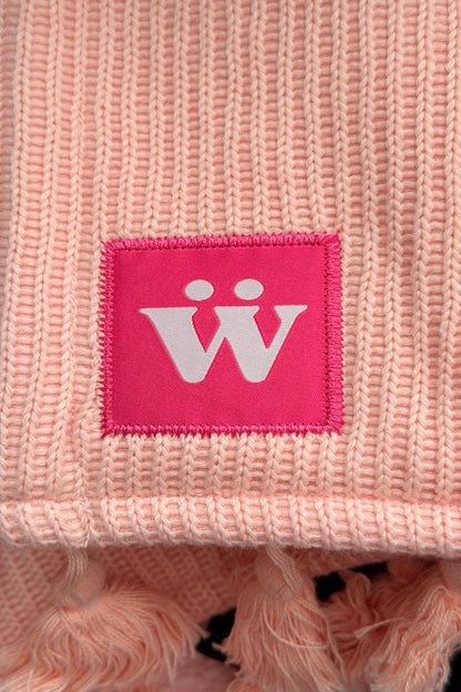 A pink tag with a warmur logo on the pink office chair blanket