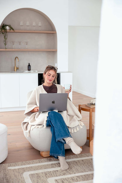 Cozy beige Warmür blanket featuring a hidden zipper, lapels, and clean professional details.