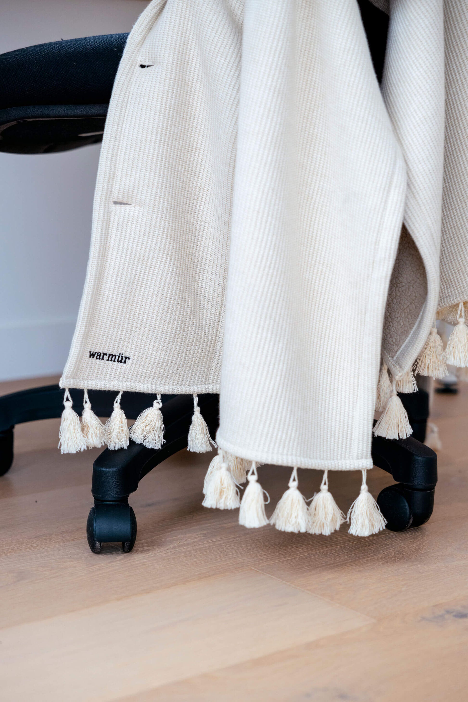 Neutral beige work-from-home blanket that adds warmth without cords or clutter.