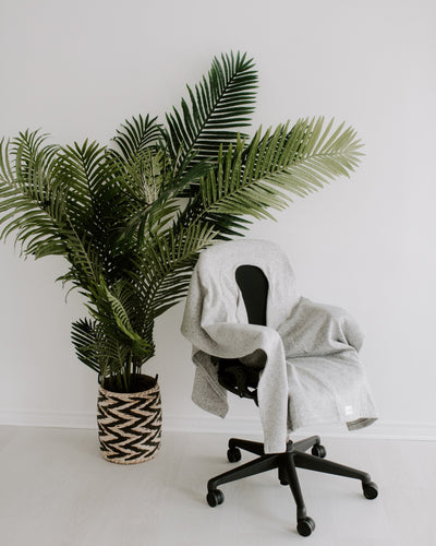 Warmür office chair blanket neatly fitted on an ergonomic desk chair, hero product shot